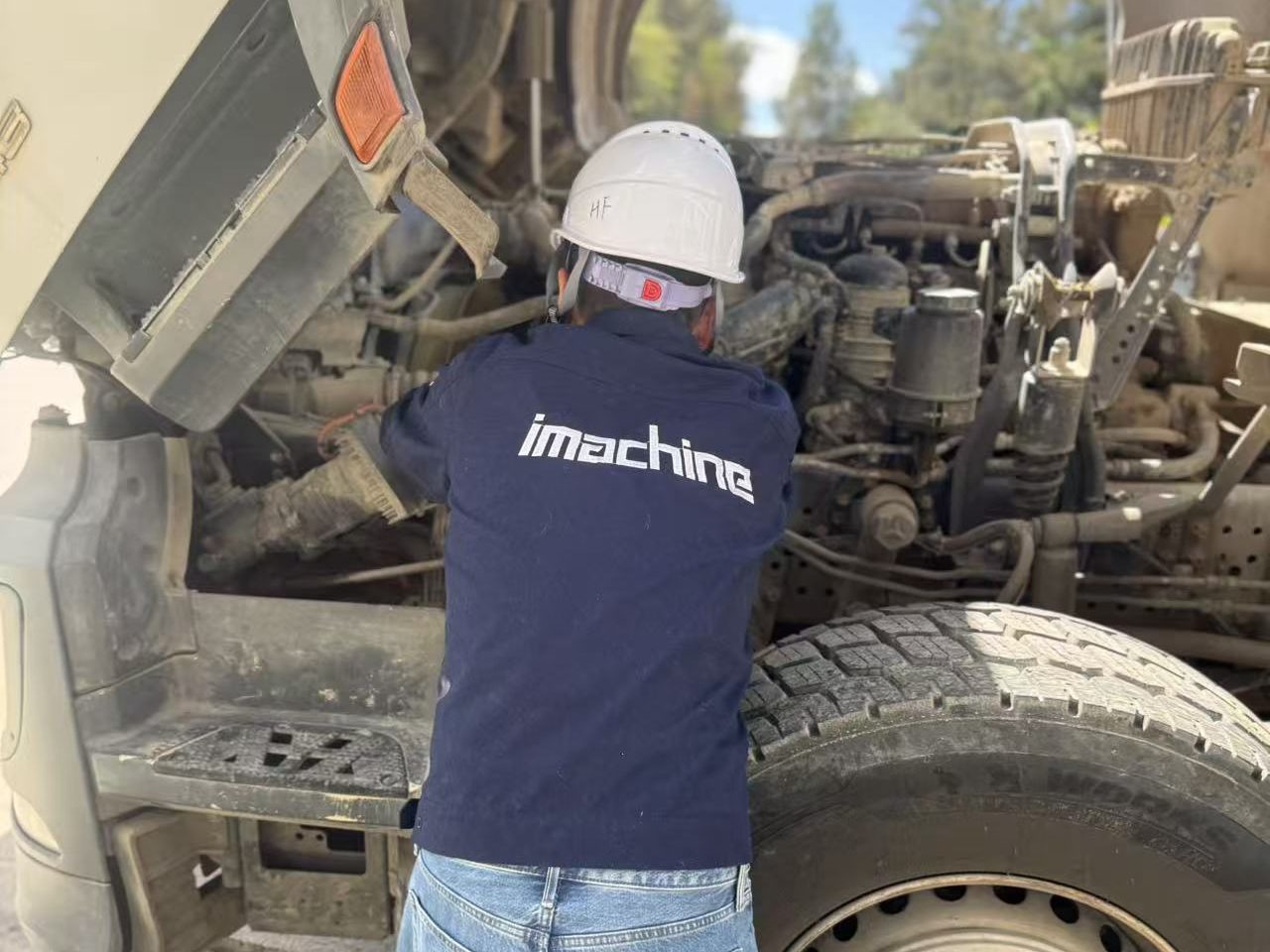 imachine engineer performing deep technical inspection on used machinery at Ethiopia construction site.