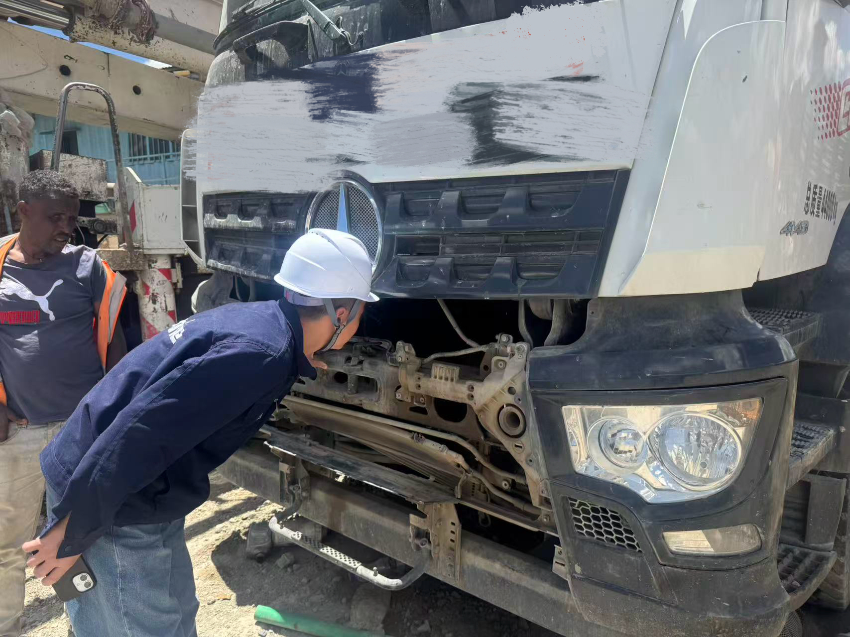 imachine engineer performing deep technical inspection on used machinery at Ethiopia construction site.